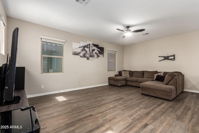 living area with a ceiling fan, visible vents, baseboards, and wood finished floors