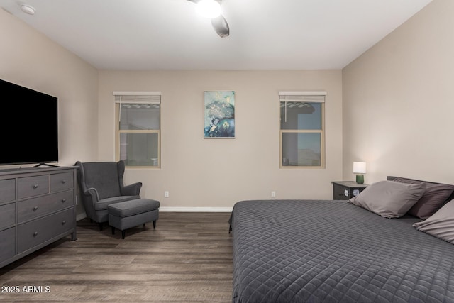 bedroom with baseboards and wood finished floors