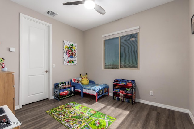 bedroom featuring ceiling fan, wood finished floors, visible vents, and baseboards