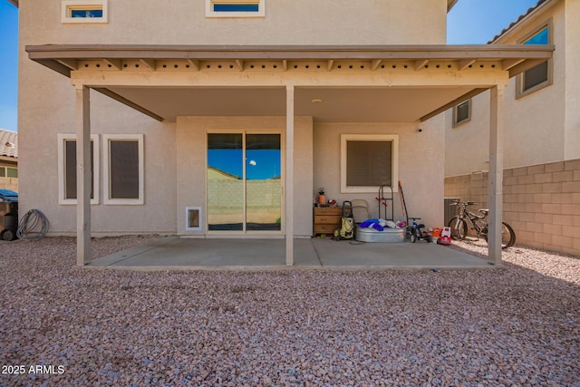 back of property with a patio area, fence, and stucco siding