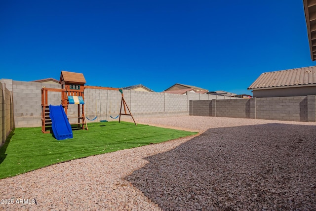 view of jungle gym with a fenced backyard and a lawn