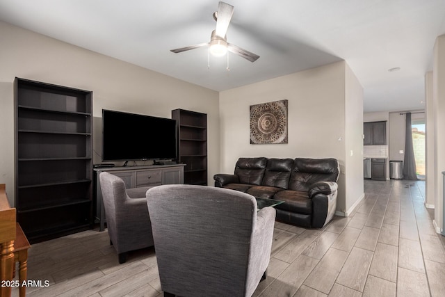 living room featuring ceiling fan and wood finish floors