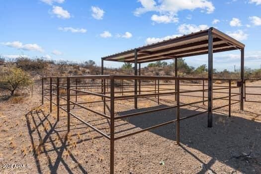 view of horse barn with a rural view