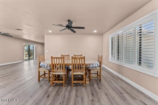 dining room featuring light hardwood / wood-style flooring and ceiling fan