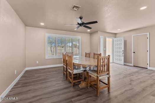 dining area featuring hardwood / wood-style flooring and ceiling fan