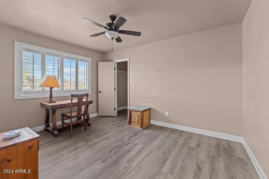 office area with light hardwood / wood-style floors and ceiling fan