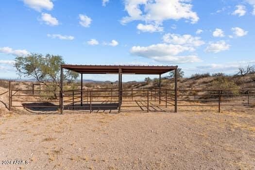 view of community with an outdoor structure and a rural view