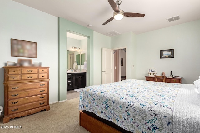 bedroom featuring visible vents, light carpet, connected bathroom, and a ceiling fan