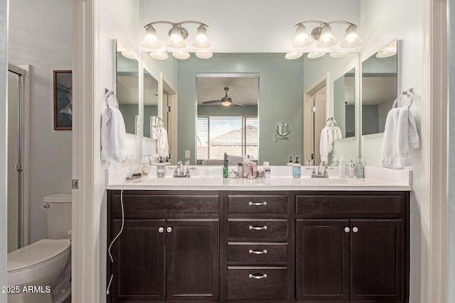 full bath featuring a sink, a ceiling fan, toilet, and double vanity