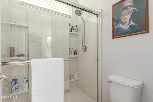 bathroom with a stall shower and toilet