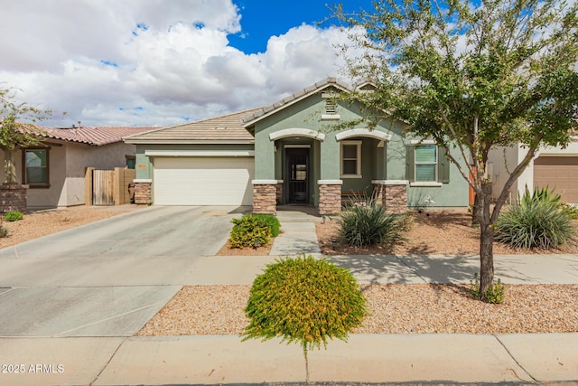 view of front of home with fence, stucco siding, a garage, stone siding, and driveway