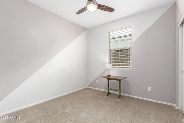 carpeted empty room with baseboards and ceiling fan