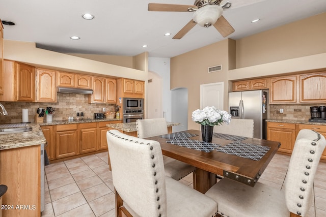 kitchen featuring tasteful backsplash, appliances with stainless steel finishes, sink, and light stone counters