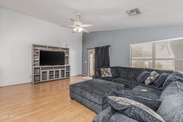 living room featuring hardwood / wood-style floors, ceiling fan, and vaulted ceiling