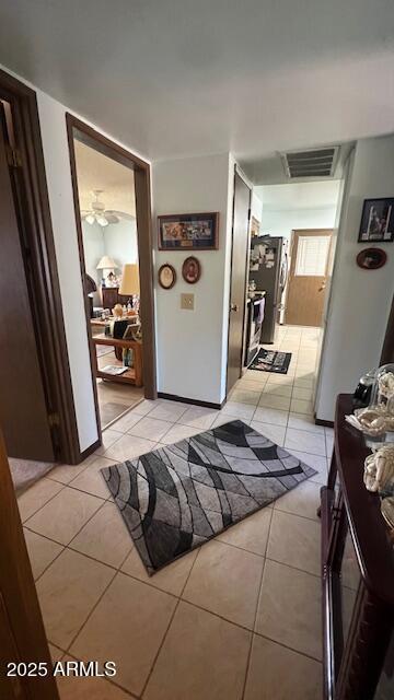hallway with light tile patterned floors and visible vents