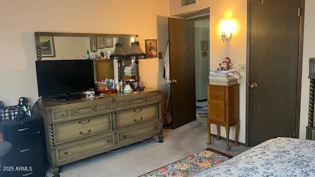 carpeted bedroom featuring visible vents
