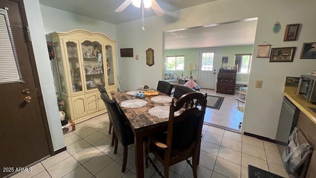 dining room featuring light tile patterned floors and ceiling fan