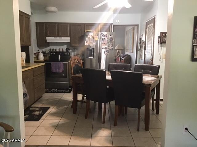 dining space with ceiling fan and light tile patterned floors
