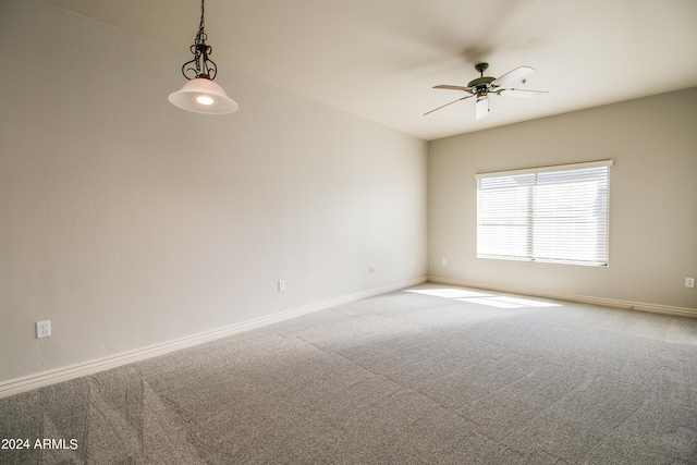 empty room with ceiling fan and carpet floors