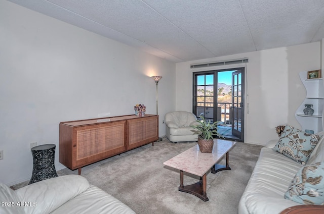 living room with light colored carpet and a textured ceiling