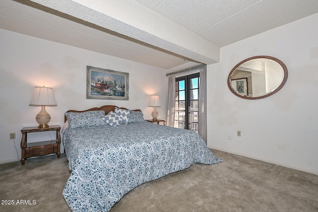 bedroom featuring carpet flooring and a textured ceiling