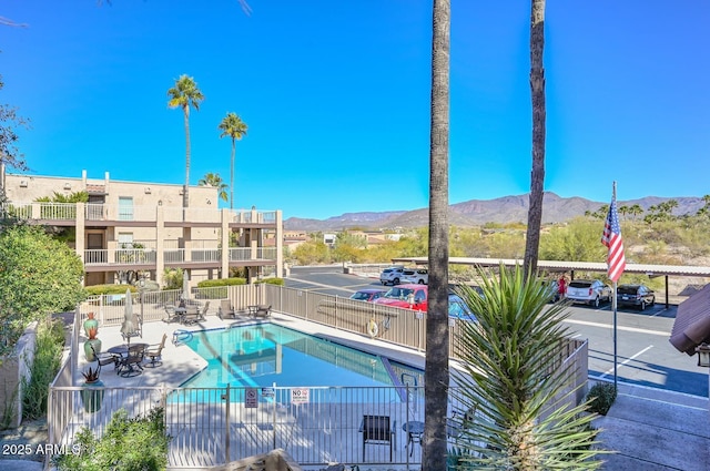 view of pool with a patio and a mountain view