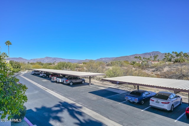 view of parking with a carport and a mountain view