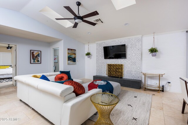 8338 E Monterosa St, Scottsdale, AZ 85251 - living room featuring a fireplace, a ceiling fan, visible vents, light tile patterned flooring, and lofted ceiling with skylight
