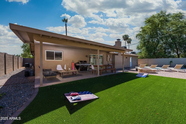 8338 E Monterosa St, Scottsdale, AZ 85251 - rear view of house with a yard, an outdoor fire pit, a fenced backyard, a patio, and stucco siding