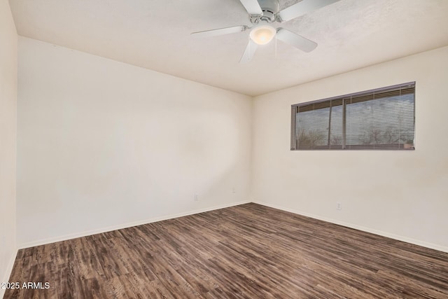 unfurnished room with ceiling fan, baseboards, and dark wood finished floors