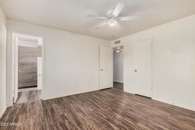 unfurnished room featuring baseboards, wood finished floors, visible vents, and a ceiling fan