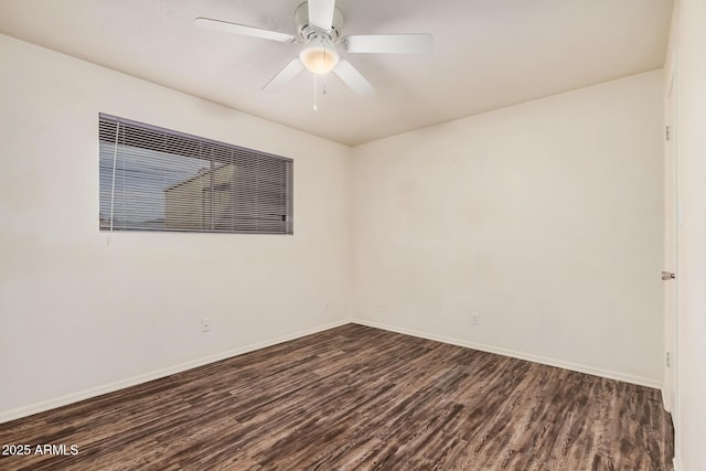 unfurnished room with dark wood-style flooring, a ceiling fan, and baseboards