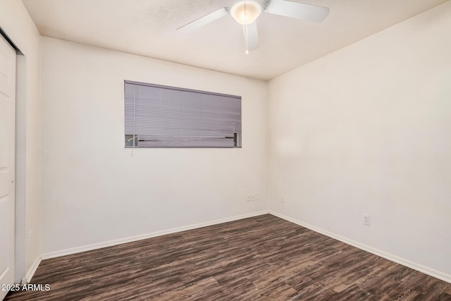 empty room with dark wood finished floors, baseboards, and ceiling fan