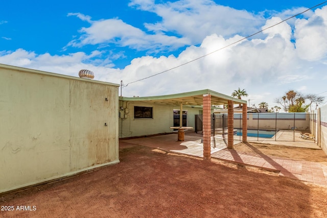 back of property with a fenced in pool, a patio area, and fence