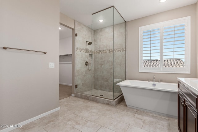 bathroom with vanity, separate shower and tub, and tile patterned flooring