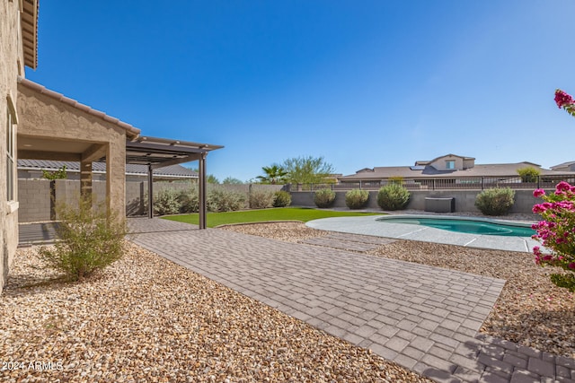 view of yard featuring a fenced in pool and a patio area