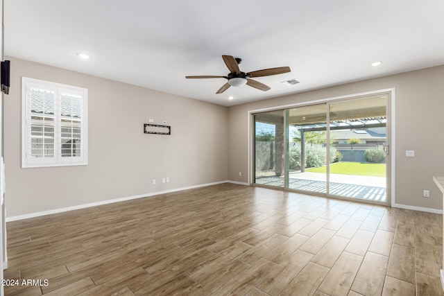 spare room featuring hardwood / wood-style floors and ceiling fan