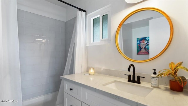 bathroom with shower / tub combo with curtain and vanity