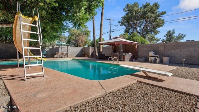 view of pool with a fenced in pool, a fenced backyard, a gazebo, a patio area, and a diving board