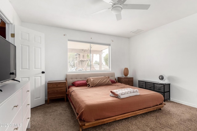 carpeted bedroom with visible vents, baseboards, and ceiling fan