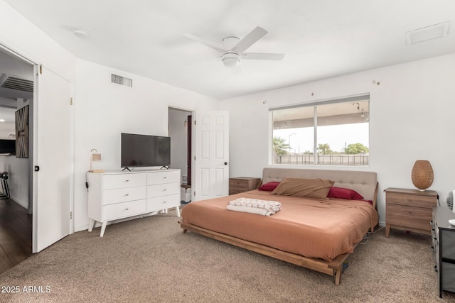 carpeted bedroom featuring visible vents and a ceiling fan