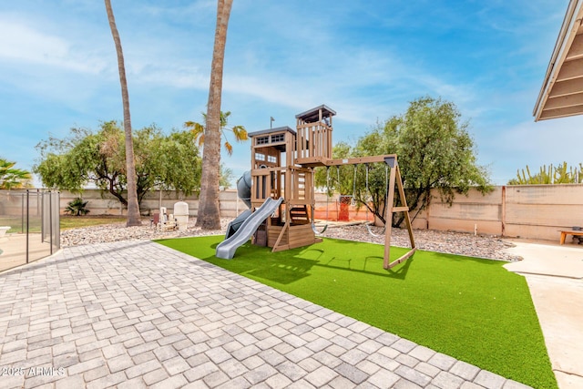 view of play area featuring a patio and a fenced backyard