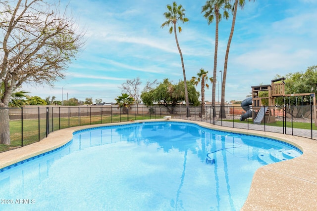 view of swimming pool with a fenced in pool, a playground, and fence