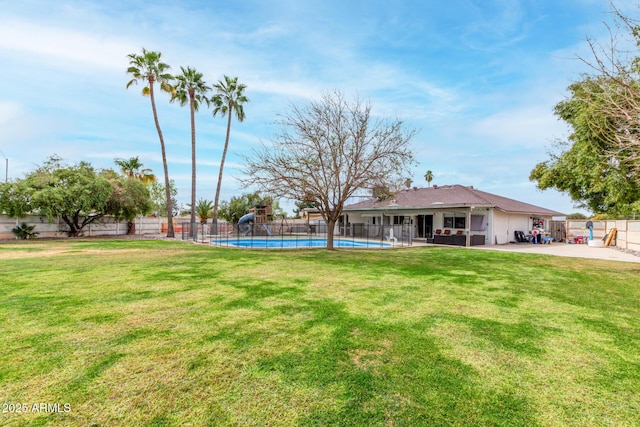 view of yard featuring a patio area, a fenced backyard, and a fenced in pool