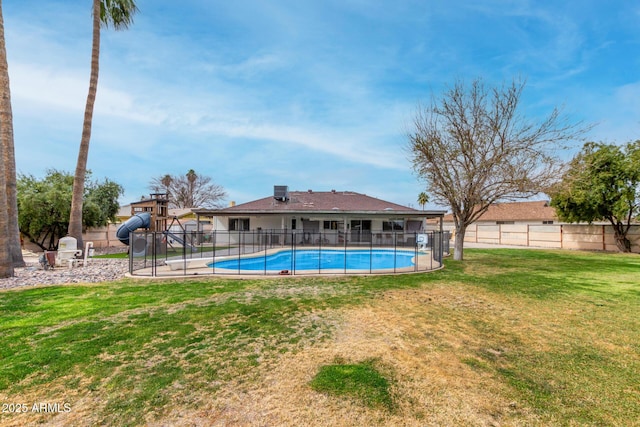 view of swimming pool with a yard, a fenced in pool, and fence