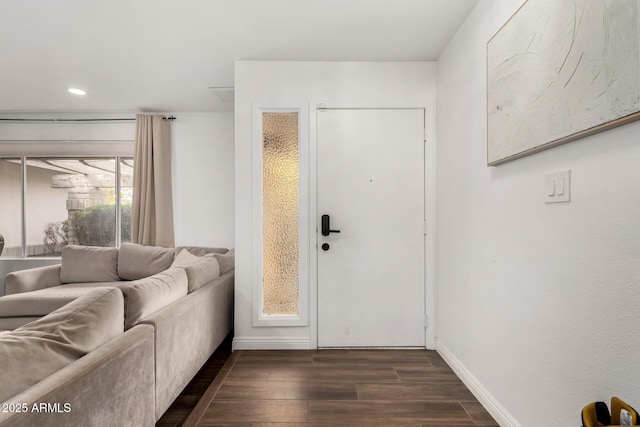 interior space featuring recessed lighting, baseboards, and dark wood-style flooring