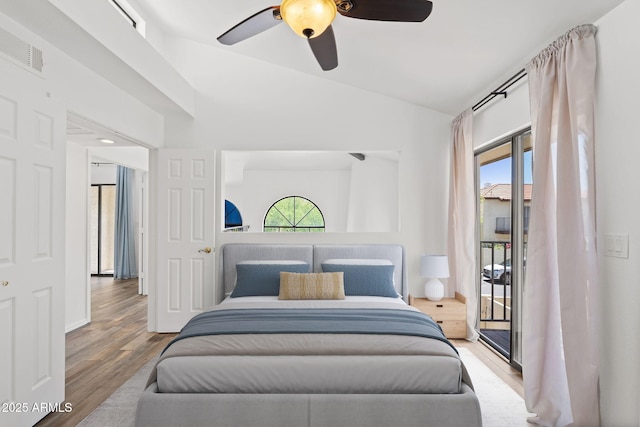 8844 S 51st St Unit 3, Phoenix, AZ 85044 - bedroom featuring ceiling fan, visible vents, access to exterior, vaulted ceiling, and wood finished floors