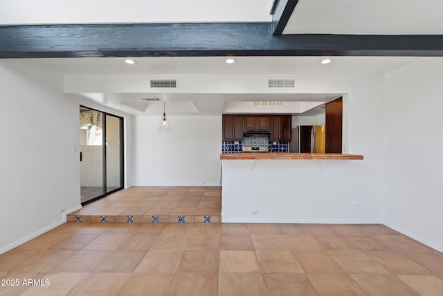 8844 S 51st St Unit 3, Phoenix, AZ 85044 - kitchen with visible vents, freestanding refrigerator, a peninsula, light tile patterned flooring, and a breakfast bar area