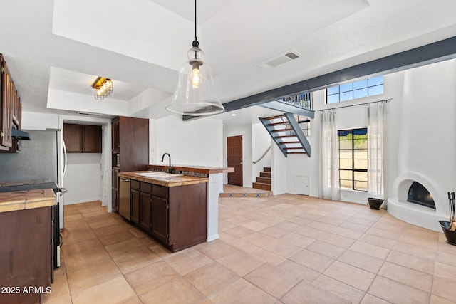 8844 S 51st St Unit 3, Phoenix, AZ 85044 - kitchen featuring visible vents, stainless steel dishwasher, dark brown cabinets, a sink, and light tile patterned floors