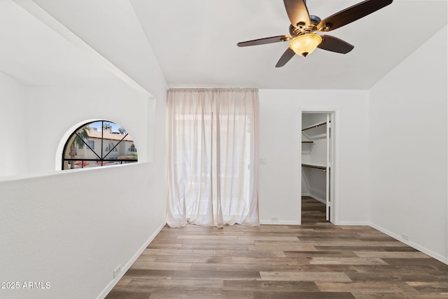 8844 S 51st St Unit 3, Phoenix, AZ 85044 - unfurnished bedroom featuring a ceiling fan, baseboards, wood finished floors, a spacious closet, and a closet